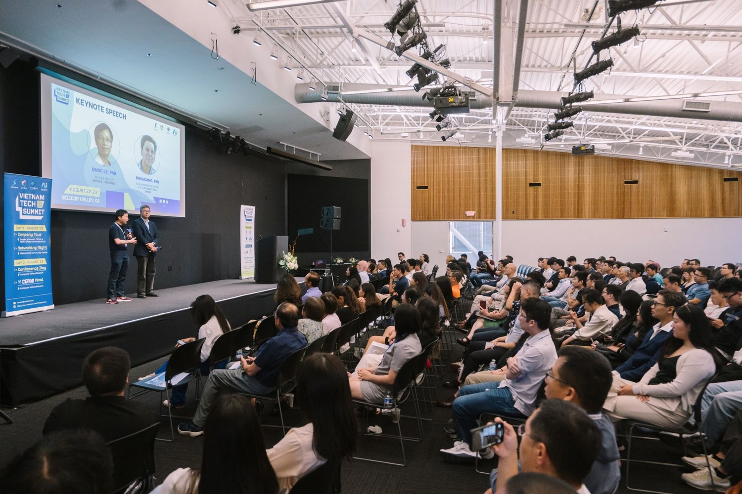 A large audience seated in a modern auditorium watches a keynote on stage at Vietnam Tech Summit in Silicon Valley.