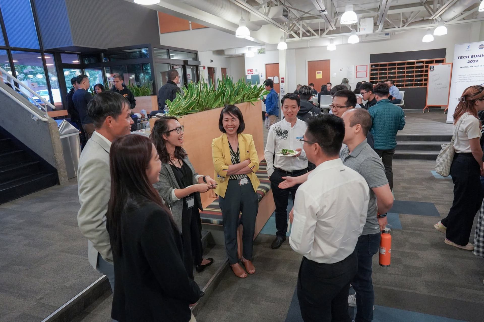 Summit attendees networking and talking with professionals during a break