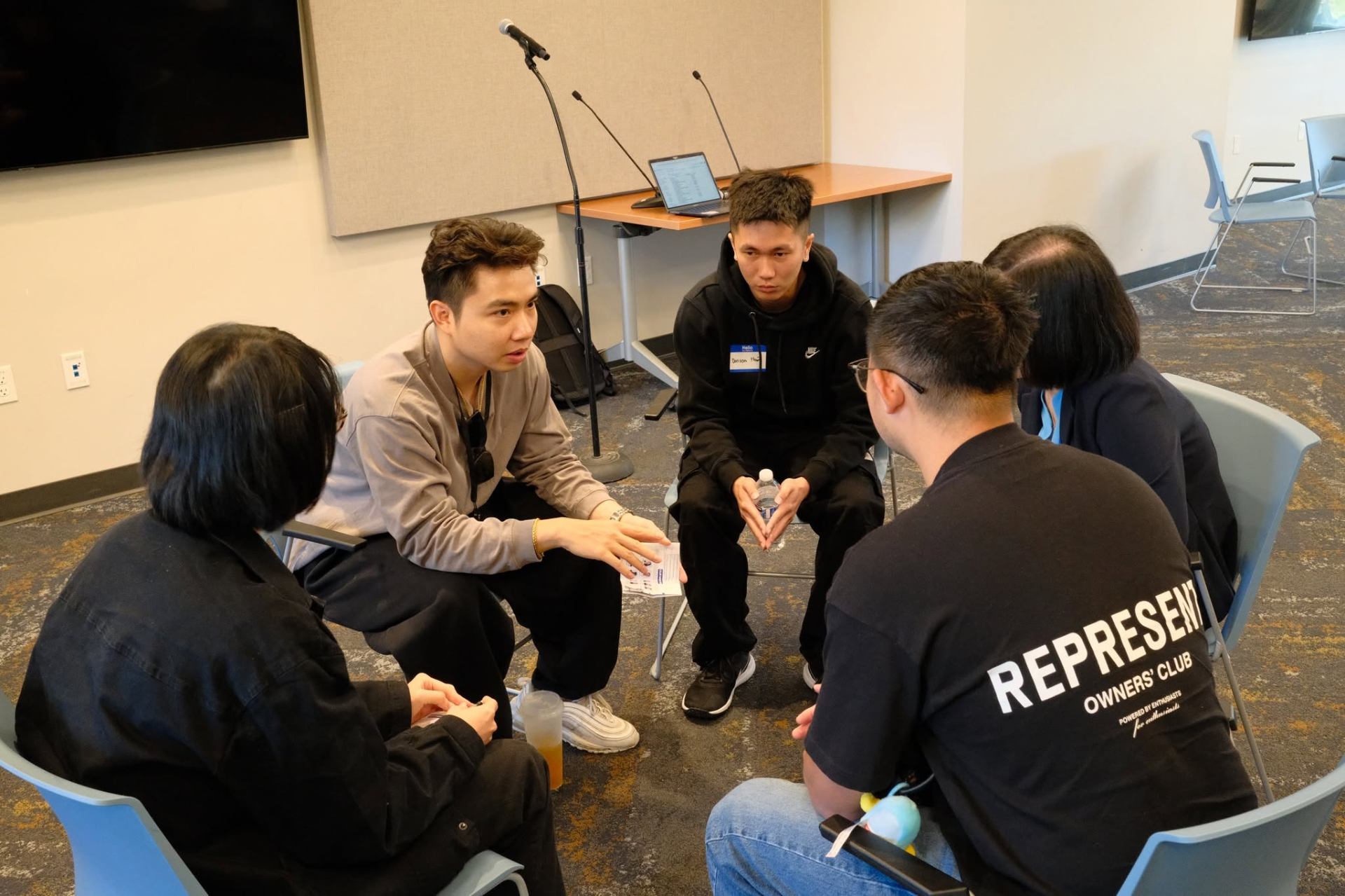 A small mentoring circle in focused discussion at the summit